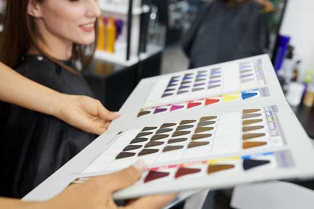Woman choosing hair color from a palette at a salon.