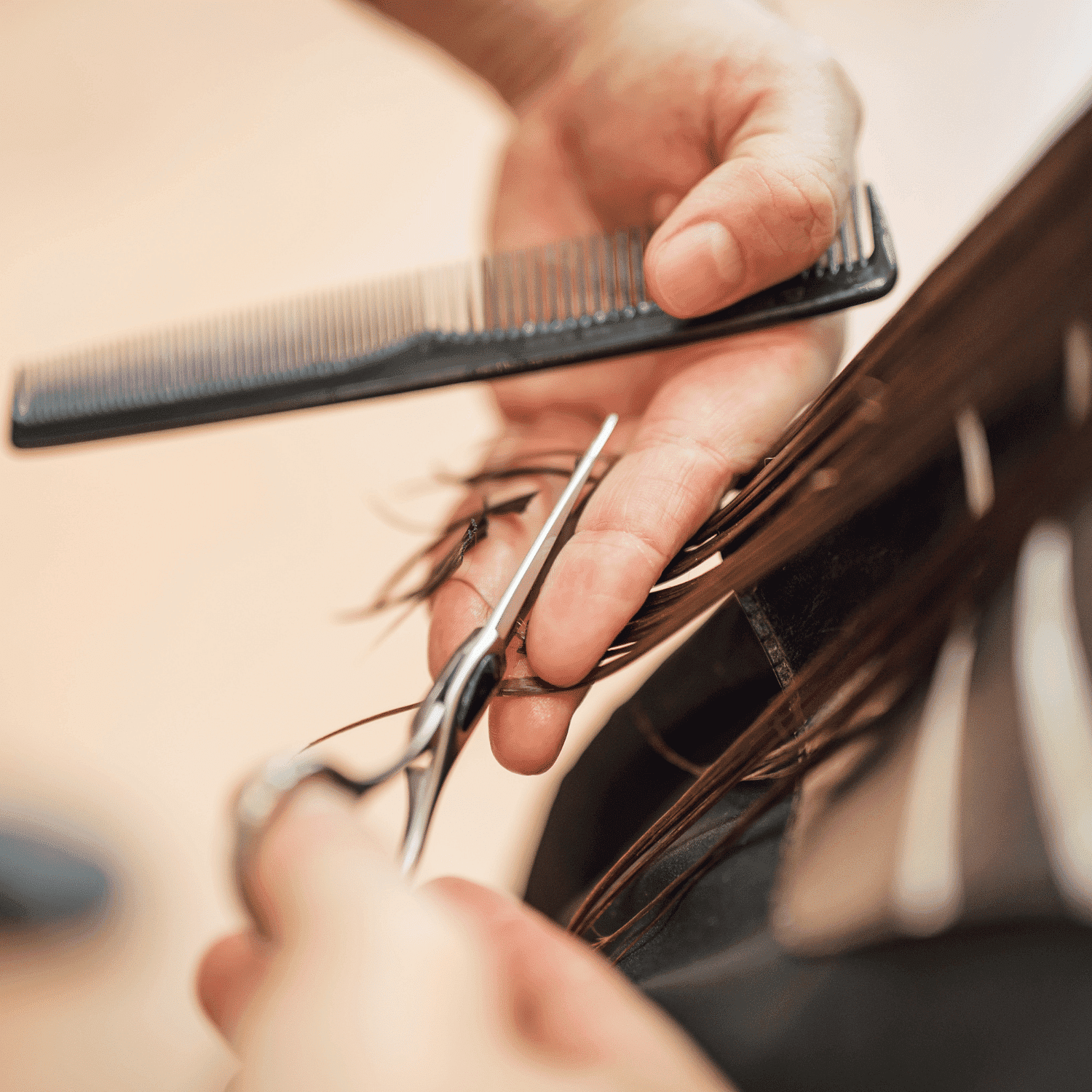 Hairdresser cutting brown hair with scissors and comb.